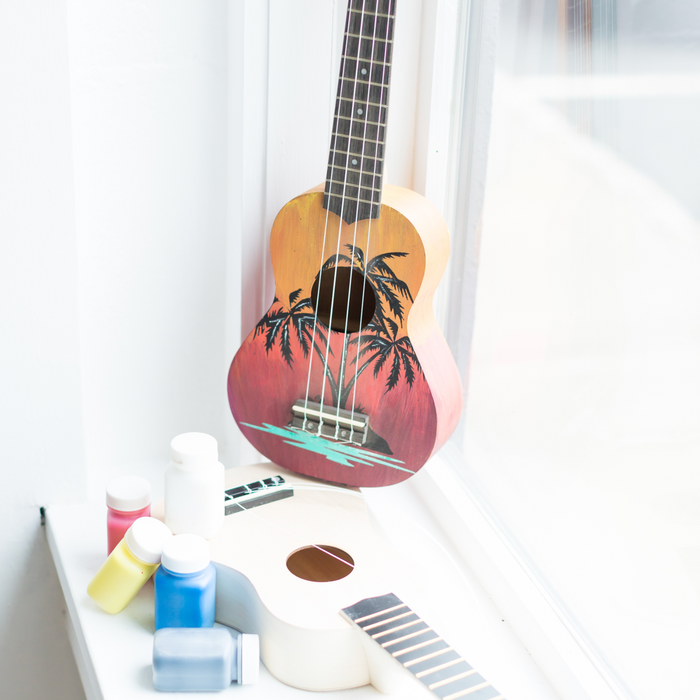 Ukulele Kit with primary paint colors and palm tree design