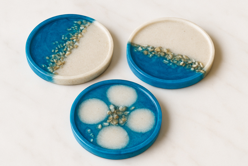 Three ceramic coasters with blue and white design on a white background